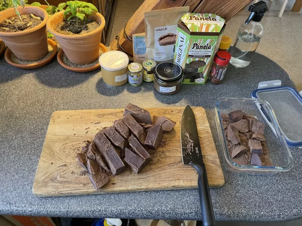 Third stage of chunking a 1kg ceremonial cacao block – thick rectangular pieces being cut and stored.